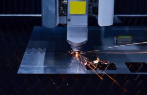 Industrial laser cut machine while cutting the sheet metal with the sparking light